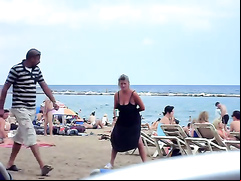 Crazy woman decides to piss on the beach sand